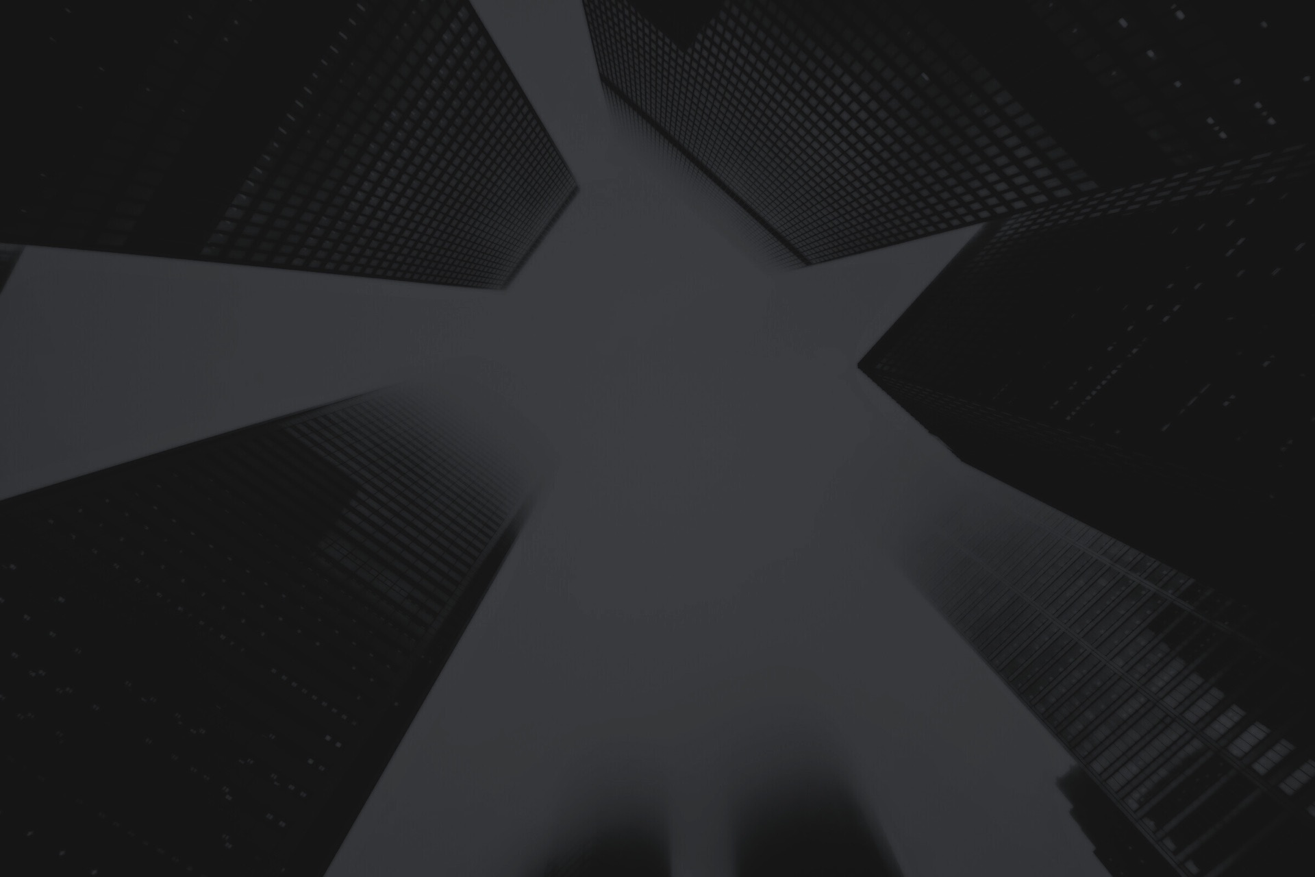 Looking up between city skyscrapers